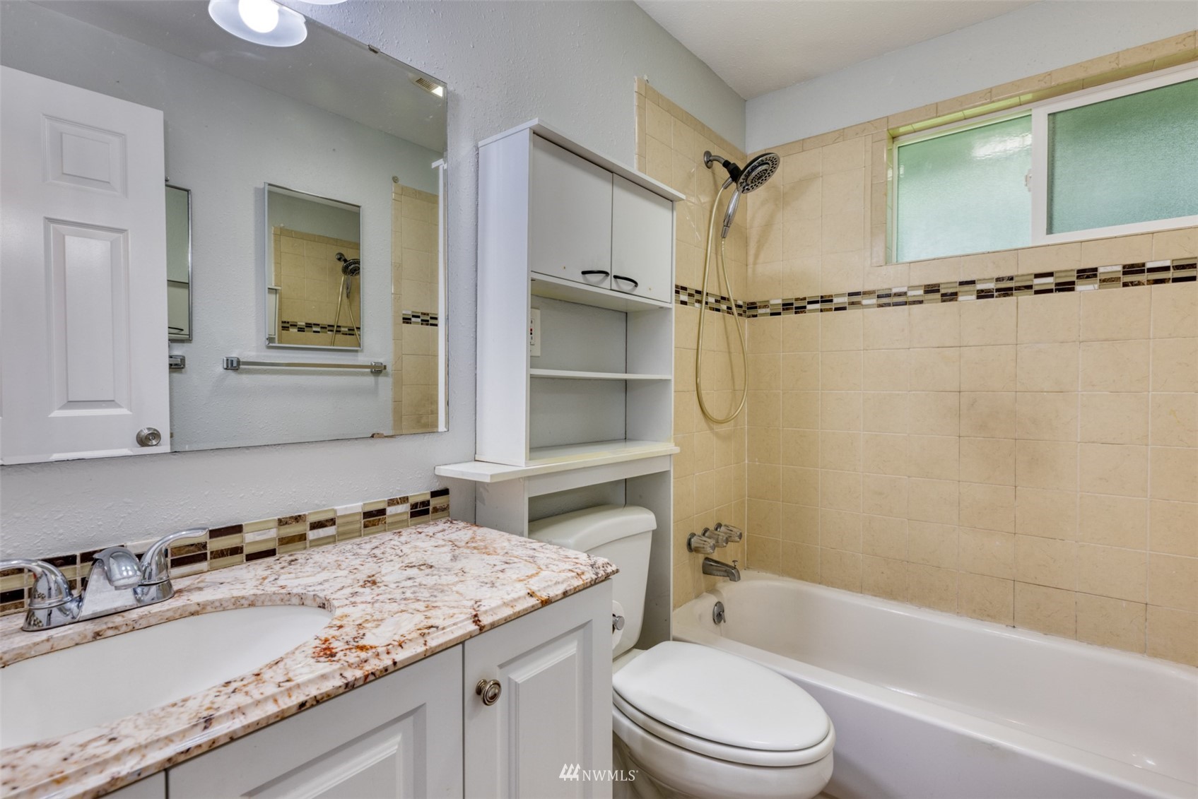 8705 Terrace Road Southwest Lakewood, WA 98498 - Photo 18 of 28 a bathroom with a granite countertop sink toilet and shower