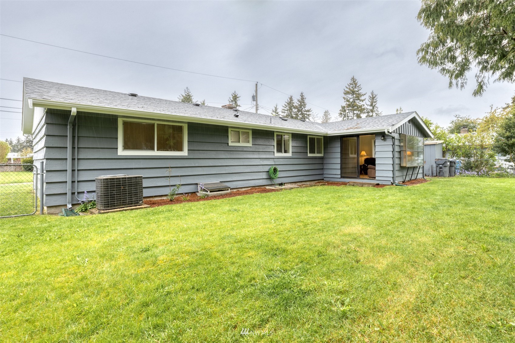 8705 Terrace Road Southwest Lakewood, WA 98498 - Photo 25 of 28 a view of a house with a backyard porch and furniture