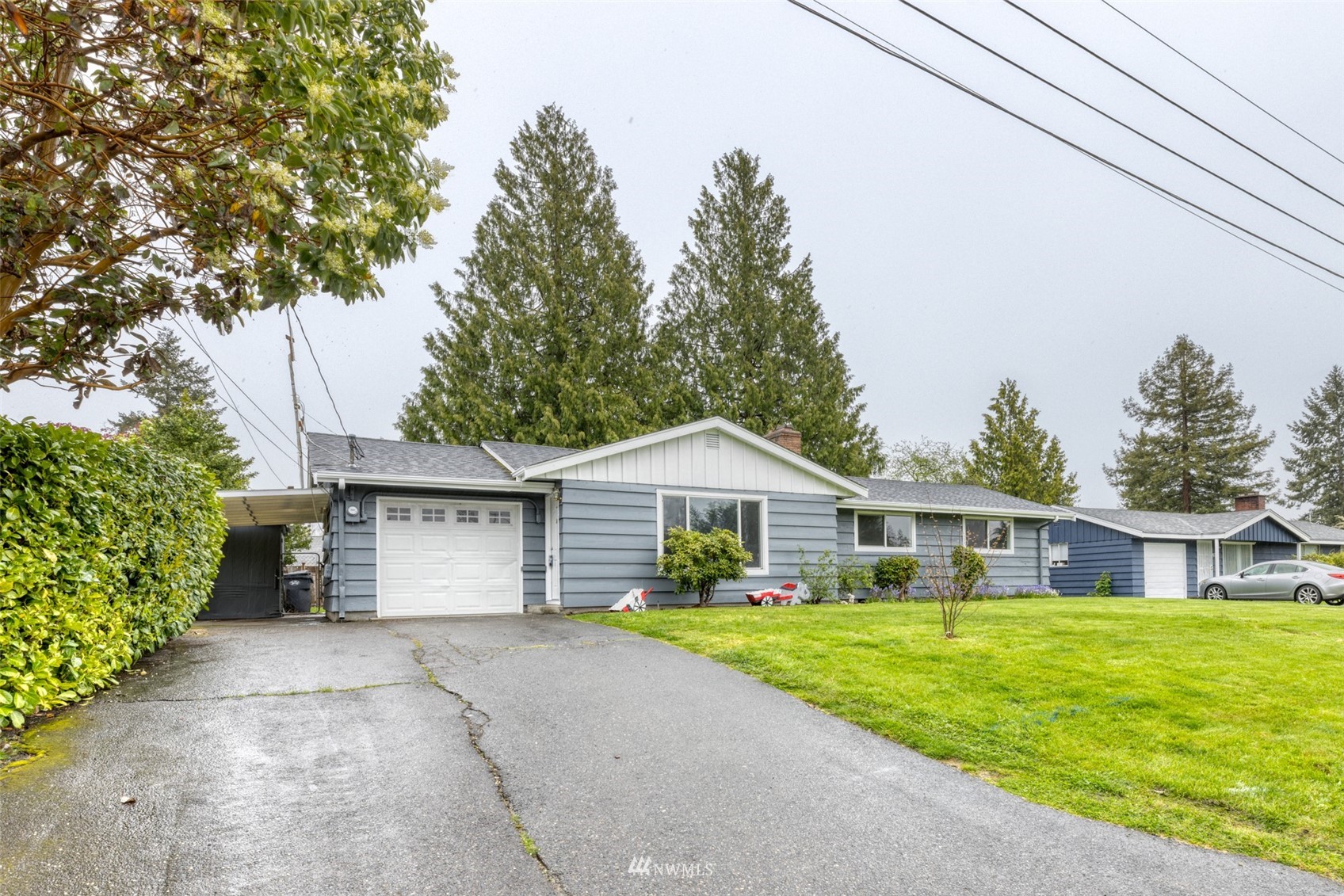 8705 Terrace Road Southwest Lakewood, WA 98498 - Photo 3 of 28 a front view of a house with a yard and garage