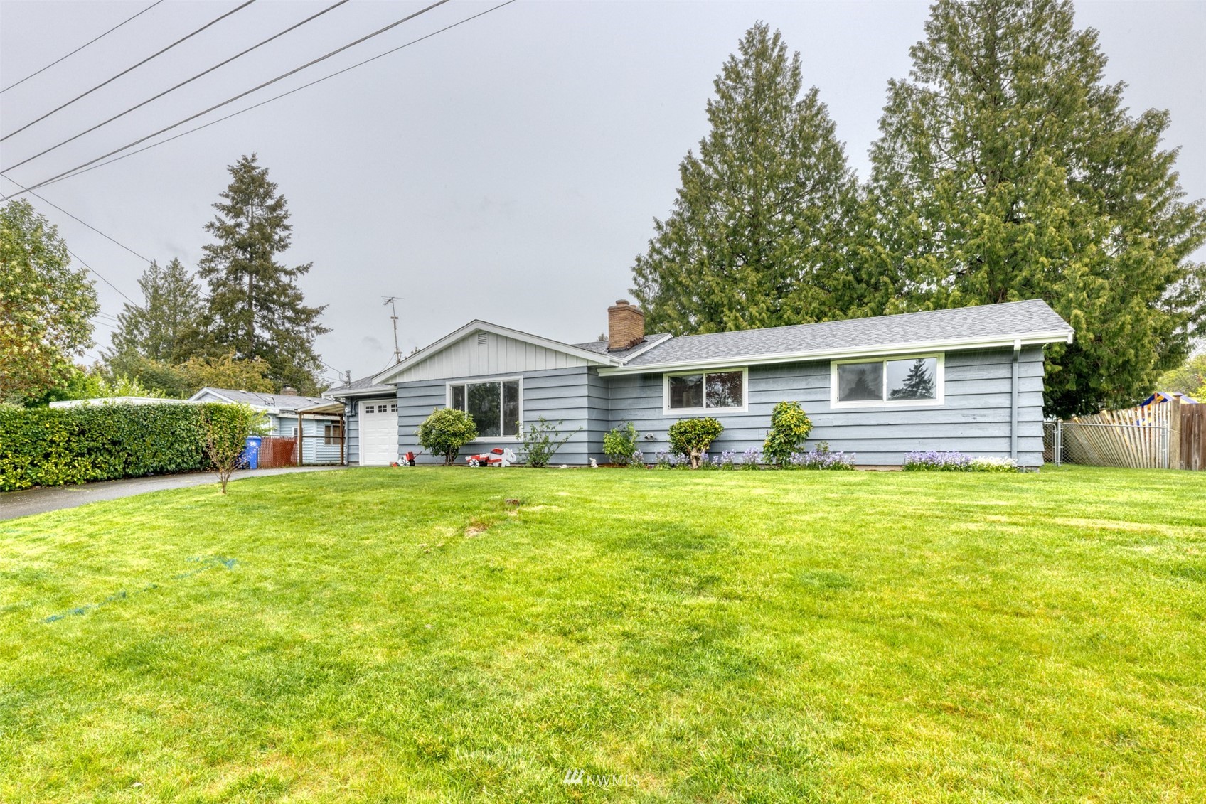 8705 Terrace Road Southwest Lakewood, WA 98498 - Photo 4 of 28 a front of house with a garden and trees