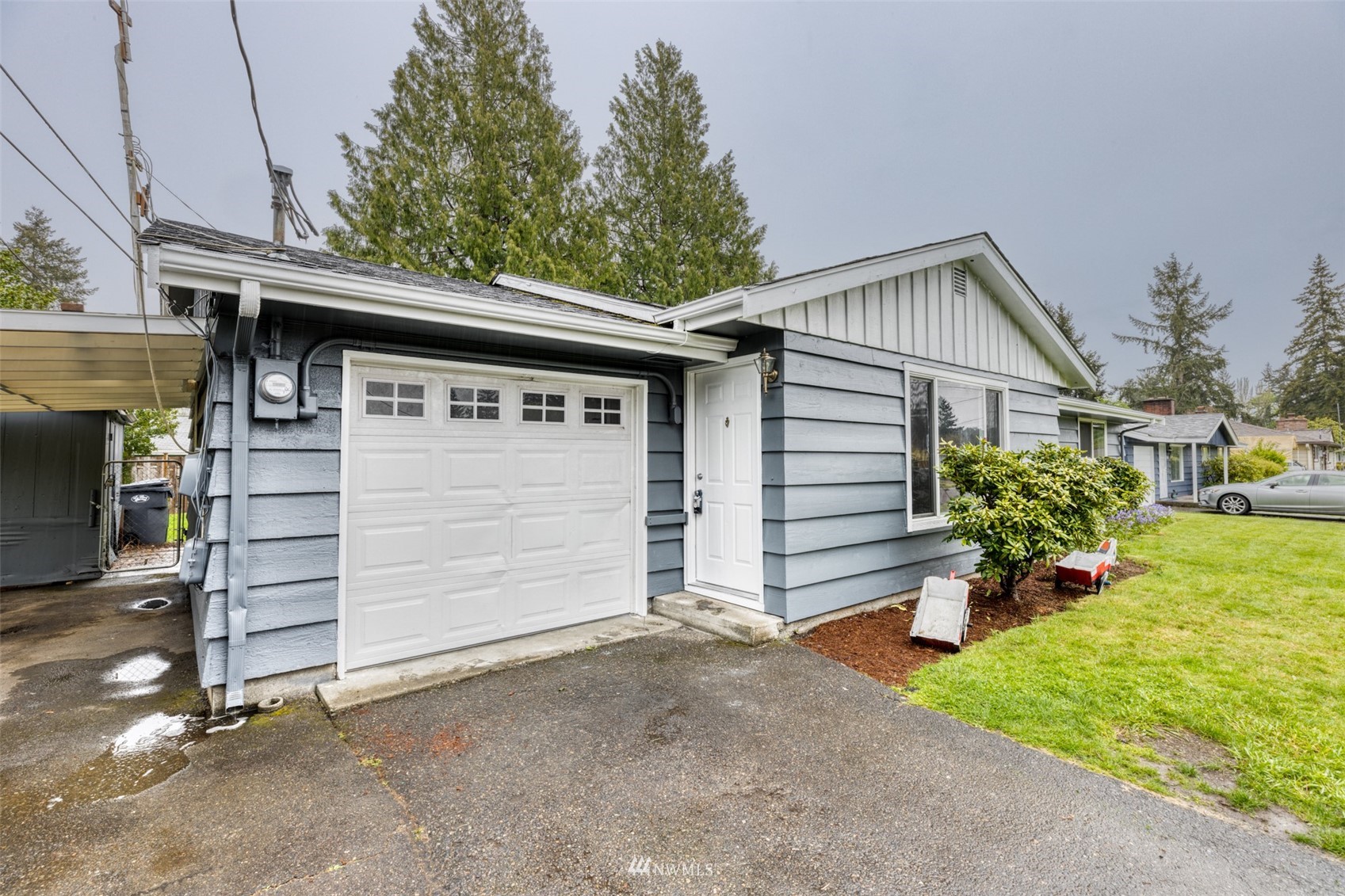 8705 Terrace Road Southwest Lakewood, WA 98498 - Photo 5 of 28 a view of a house with a garage and a yard