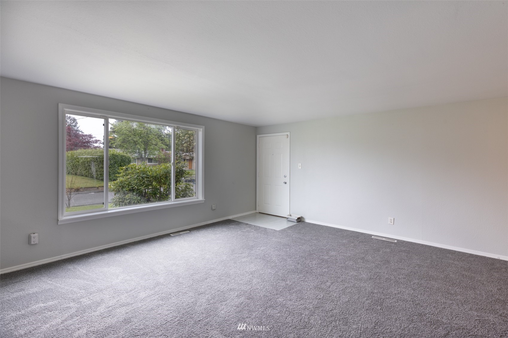 8705 Terrace Road Southwest Lakewood, WA 98498 - Photo 6 of 28 an empty room with windows and yard