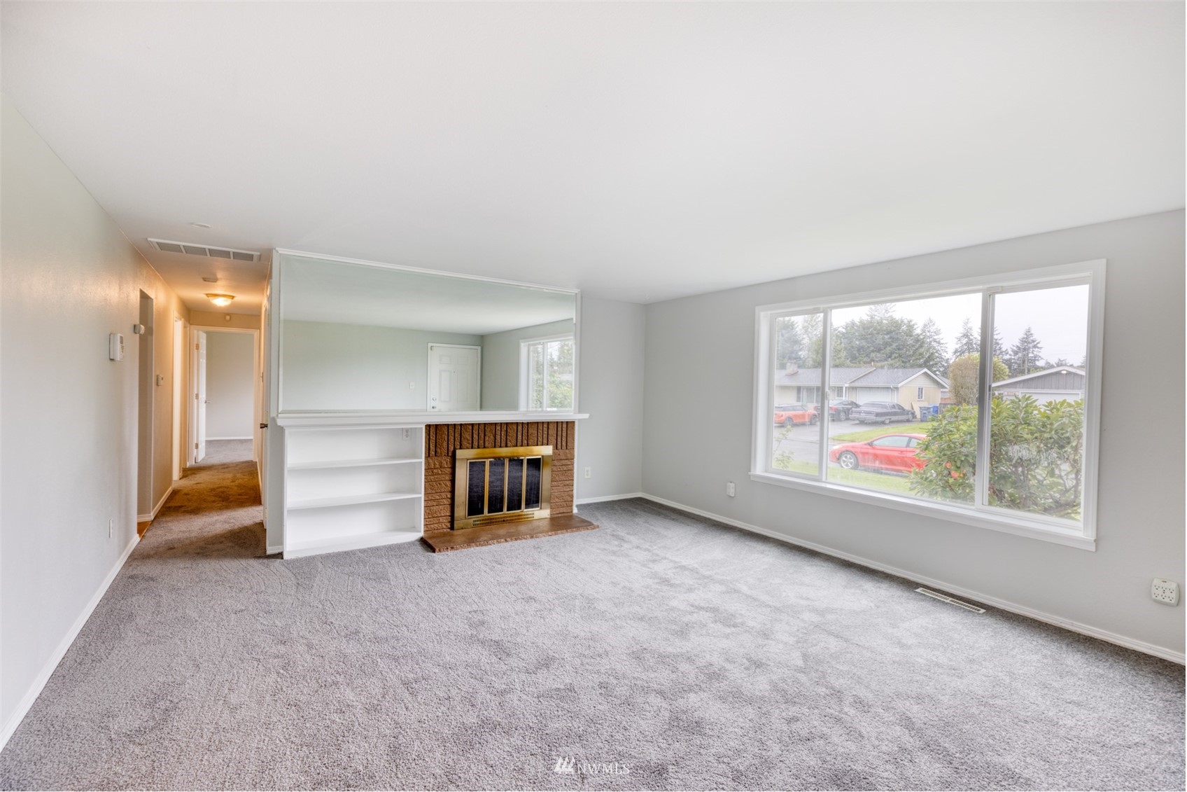 8705 Terrace Road Southwest Lakewood, WA 98498 - Photo 9 of 28 an empty room with furniture and a floor to ceiling window