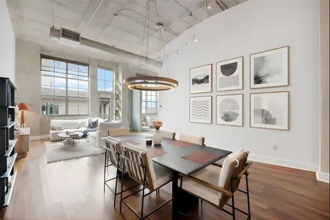 a view of a dining room with furniture wooden floor and chandelier