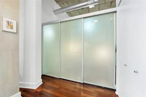 a view of empty room with wooden floor