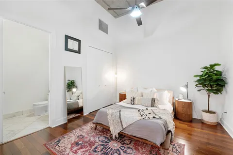 a bed room with a bed and a potted plant