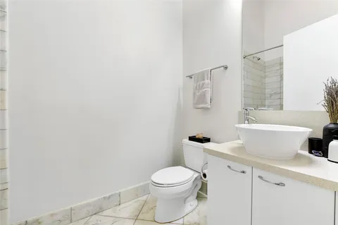 a bathroom with a toilet a sink and bathtub