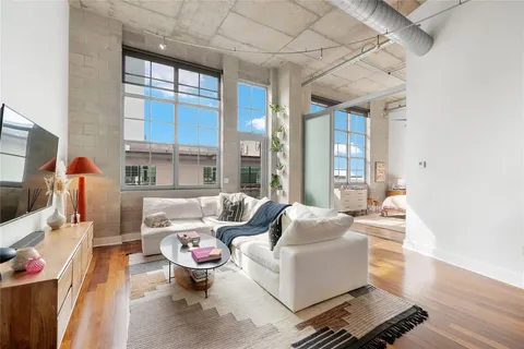 a living room with furniture and a floor to ceiling window
