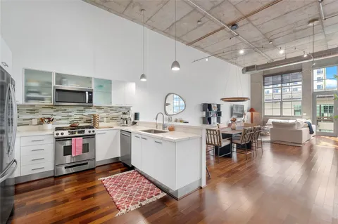a open kitchen with stainless steel appliances granite countertop a stove and cabinets