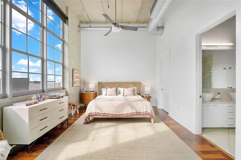 a bed room with a bed and a chair