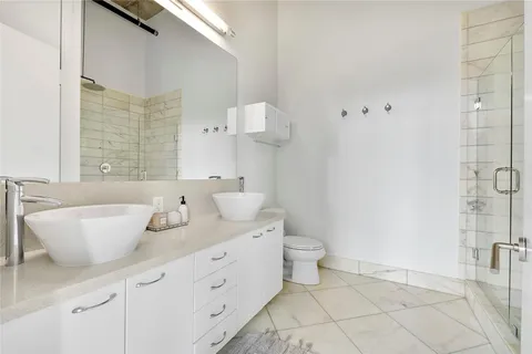 a spacious bathroom with a toilet sink and mirror