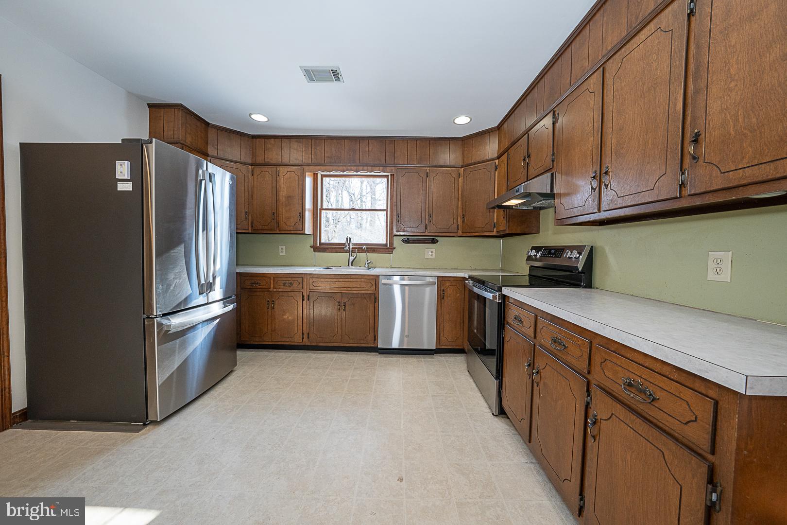 244 South Bonsall Road Coatesville, PA 19320 - Photo 16 of 48 a kitchen with stainless steel appliances granite countertop a refrigerator sink and cabinets
