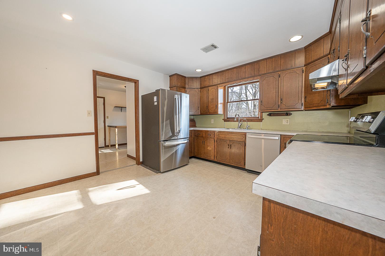 244 South Bonsall Road Coatesville, PA 19320 - Photo 18 of 48 a kitchen with stainless steel appliances granite countertop a refrigerator a sink a stove and a refrigerator