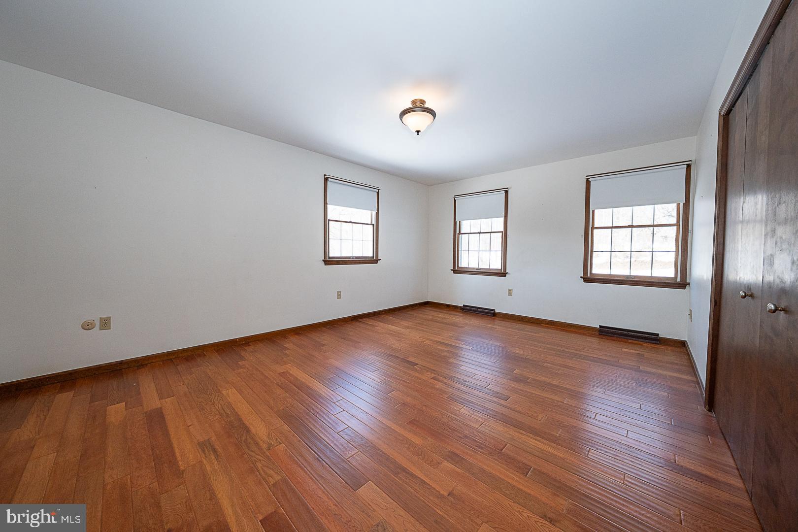 244 South Bonsall Road Coatesville, PA 19320 - Photo 21 of 48 a view of empty room with wooden floor and fan