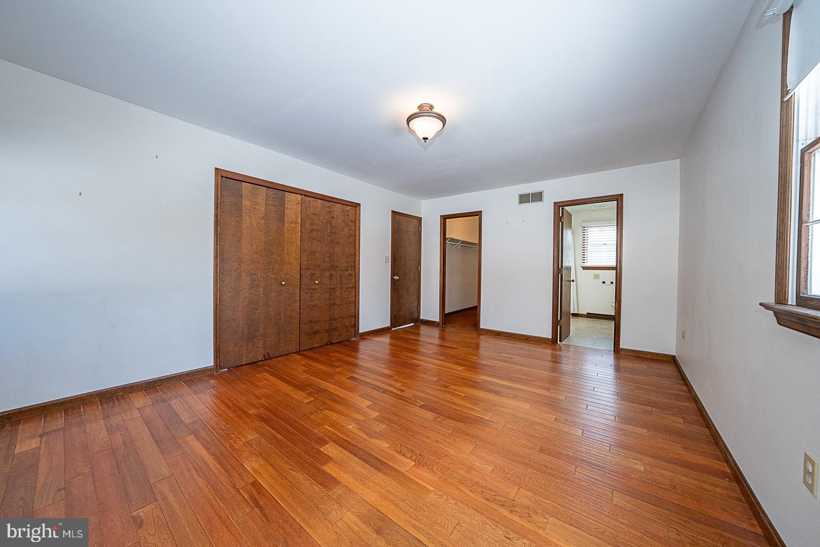244 South Bonsall Road Coatesville, PA 19320 - Photo 22 of 48 a view of an empty room with wooden floor and a window