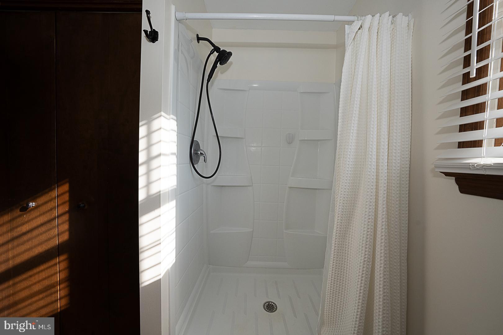 244 South Bonsall Road Coatesville, PA 19320 - Photo 27 of 48 a bathroom with a glass shower door