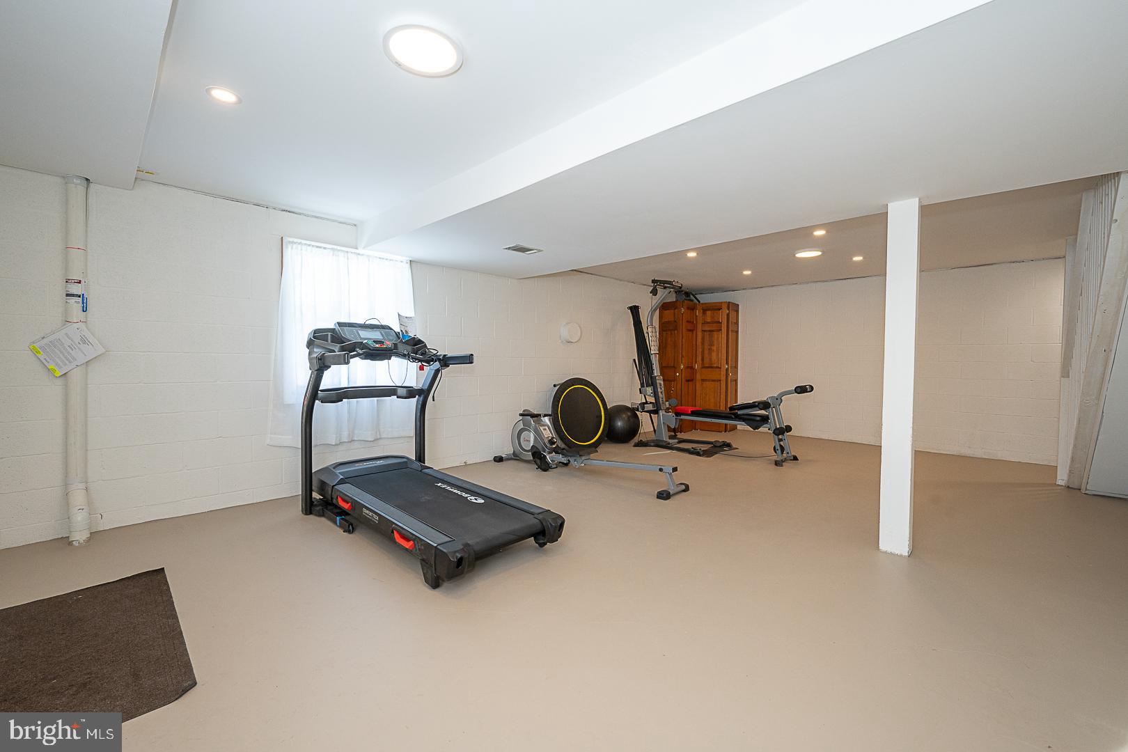 244 South Bonsall Road Coatesville, PA 19320 - Photo 32 of 48 a room with gym equipment and a large mirror