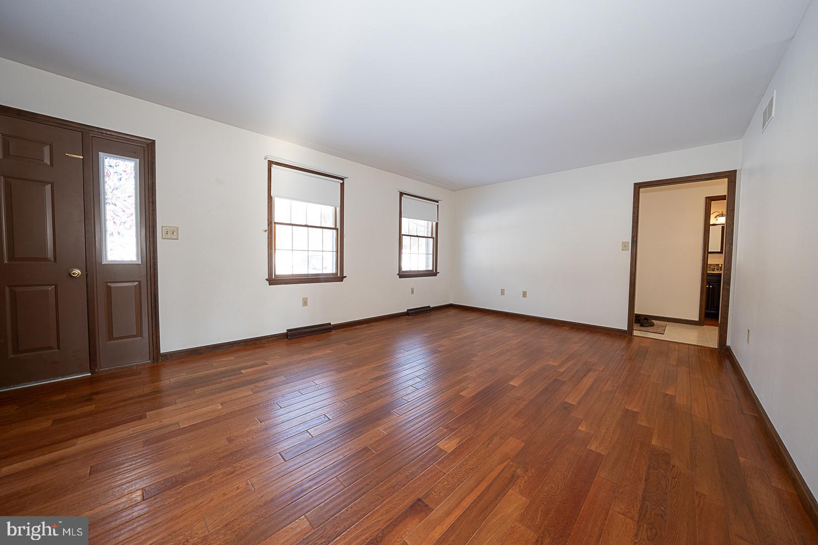 244 South Bonsall Road Coatesville, PA 19320 - Photo 6 of 48 an empty room with wooden floor and windows