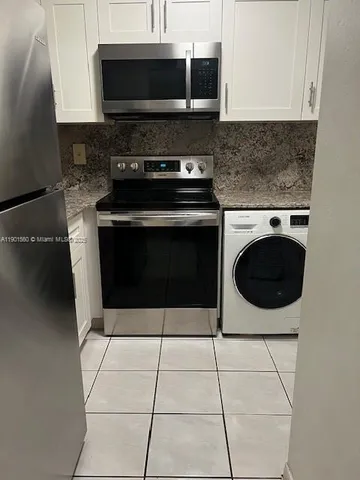 a kitchen with a stove and a microwave