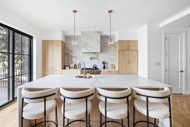 a view of a dining room with furniture a chandelier and wooden floor