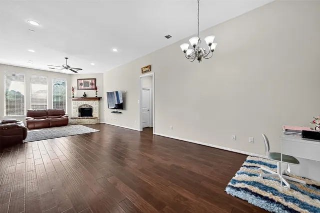 a kitchen with stainless steel appliances granite countertop a sink dishwasher a refrigerator and a stove with wooden floor