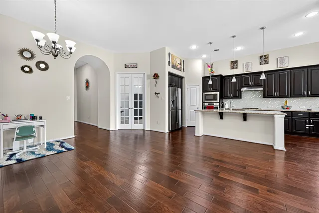 a kitchen with stainless steel appliances granite countertop a sink stove and cabinets
