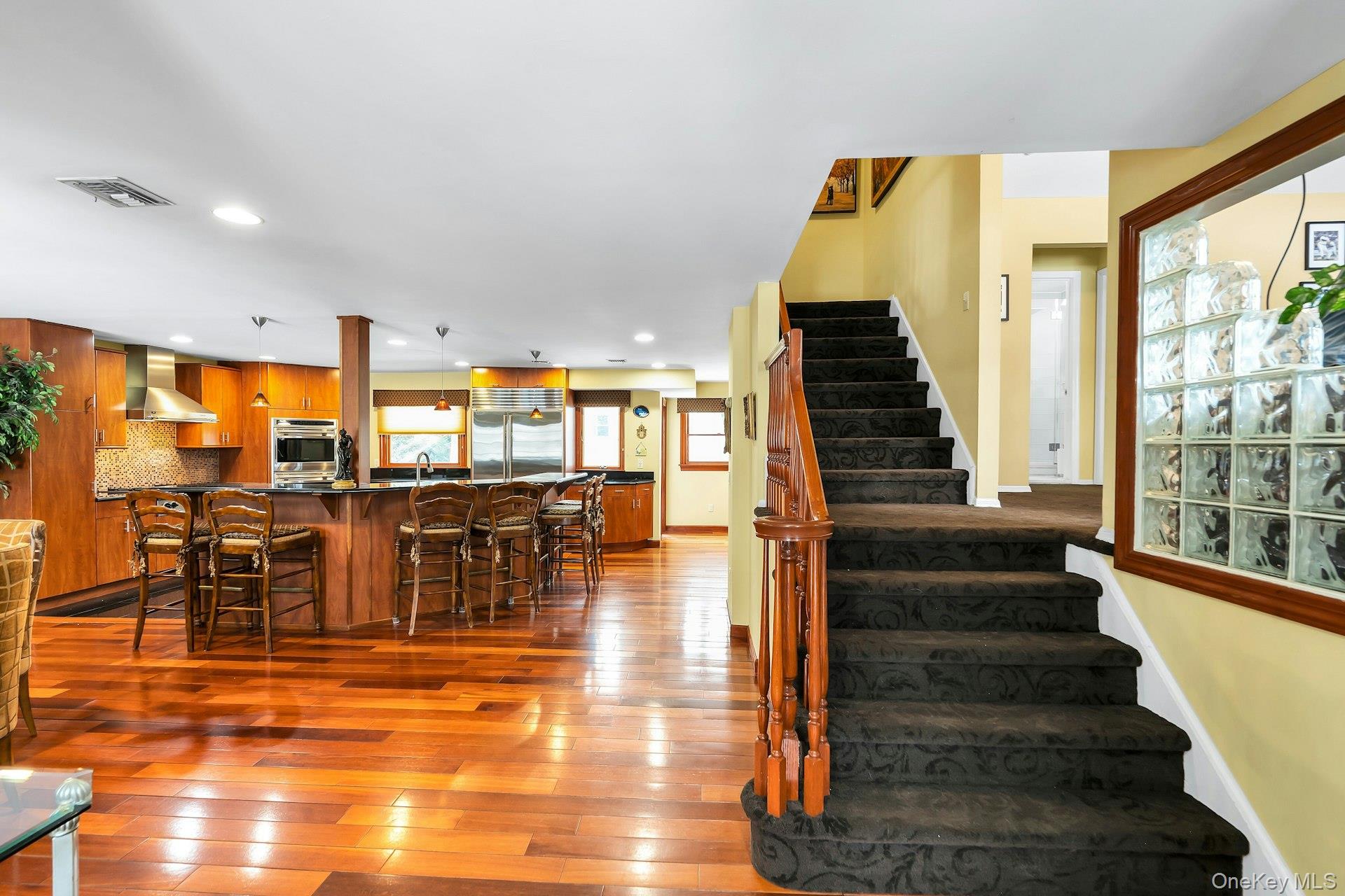 2043 Ripley Lane Merrick, NY 11566 - Photo 12 of 42 a view of a living room with balcony and dining space