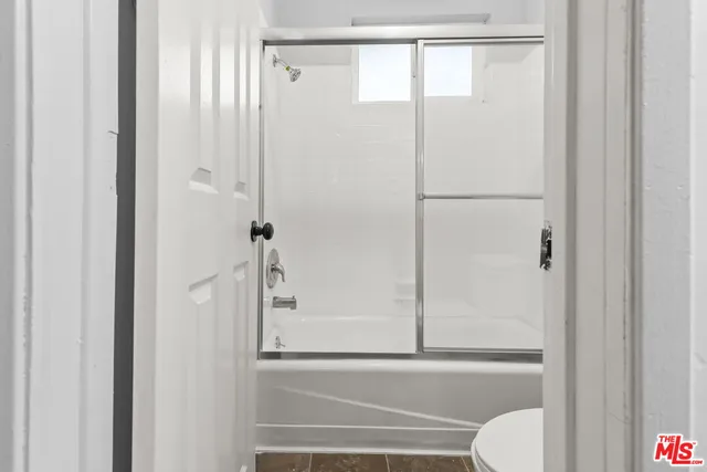 a bathroom with a shower and a toilet