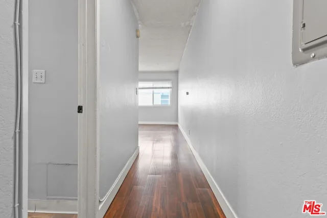 a view of a hallway with wooden floor