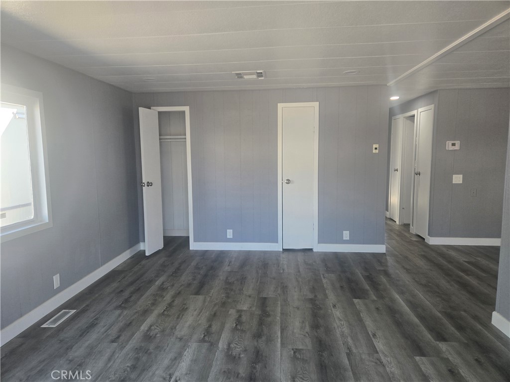1700 State, Unit 13 Hemet, CA 92543 - Photo 2 of 13 a view of an empty room with wooden floor and a window