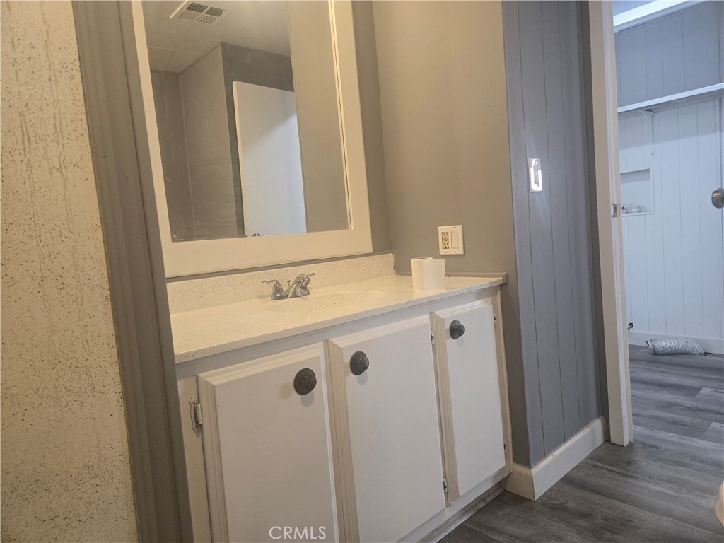 1700 State, Unit 13 Hemet, CA 92543 - Photo 6 of 13 a bathroom with a sink a mirror and a shower