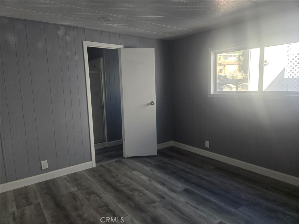 1700 State, Unit 13 Hemet, CA 92543 - Photo 9 of 13 an empty room with wooden floor and windows
