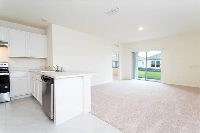a view of a kitchen with a sink and cabinets