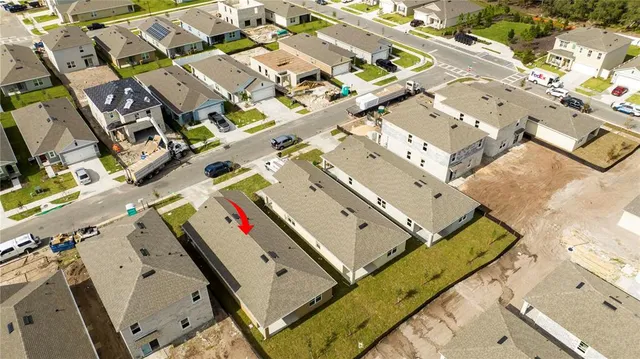 a view of a house with swimming pool and sitting area