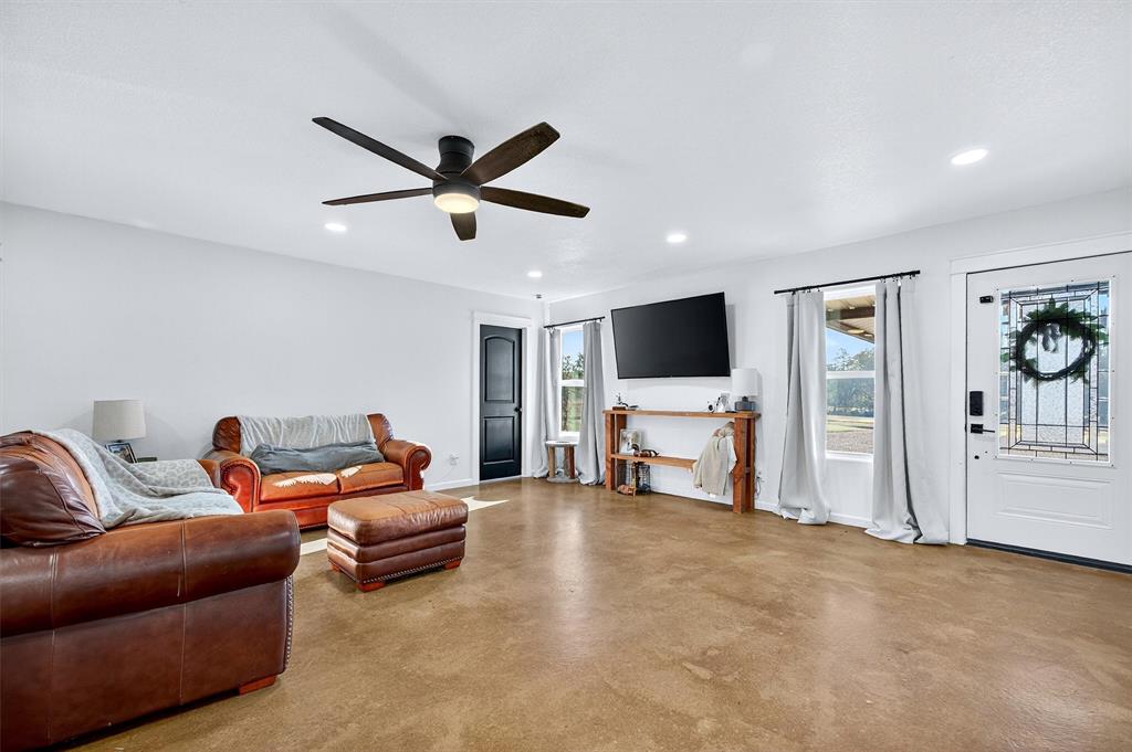 1700 Elmore Road Denison, TX 75021 - Photo 14 of 36 a living room with furniture and a flat screen tv