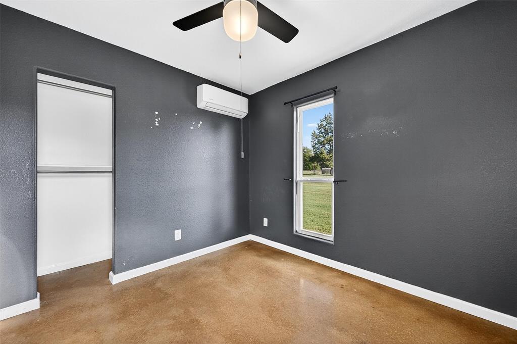 1700 Elmore Road Denison, TX 75021 - Photo 19 of 36 an empty room with windows and closet