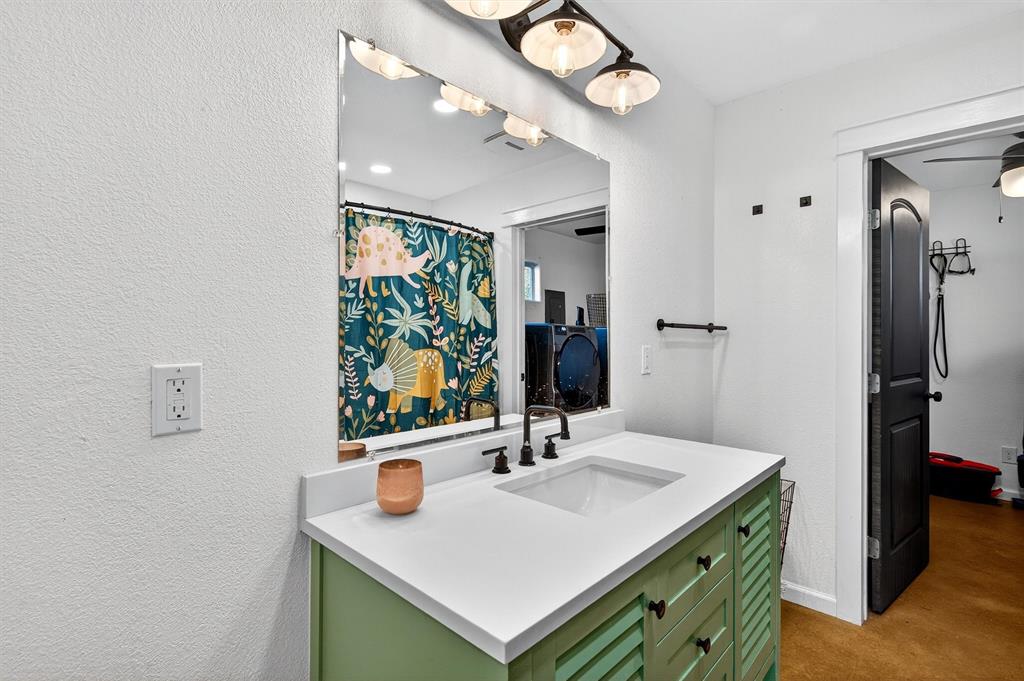 1700 Elmore Road Denison, TX 75021 - Photo 20 of 36 a bathroom with a sink and a mirror