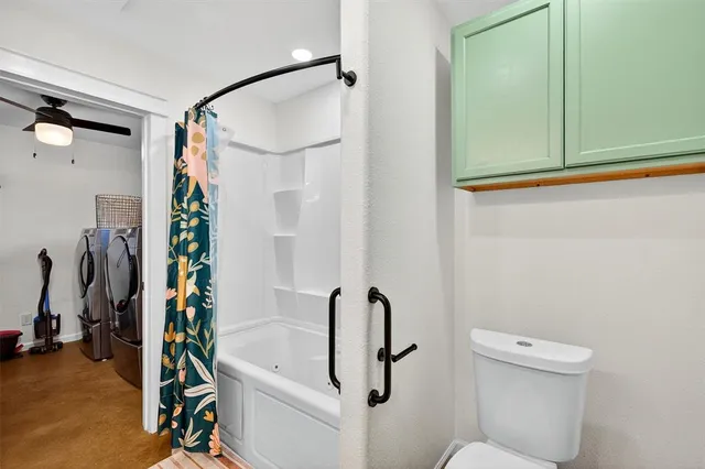 a bathroom with a shower a toilet and a sink