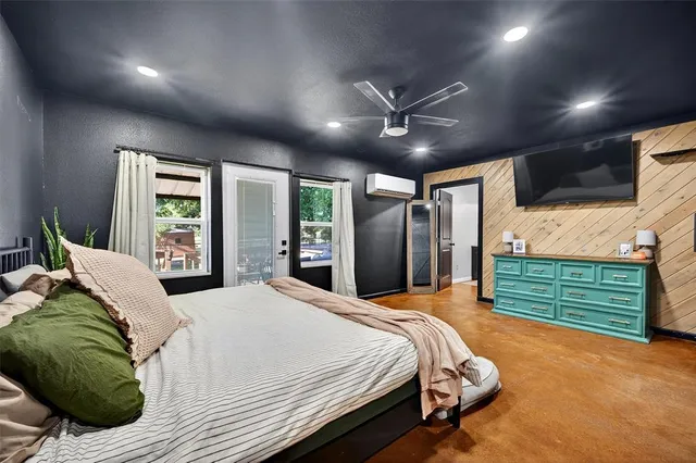 a bed room with a bed mirror and window