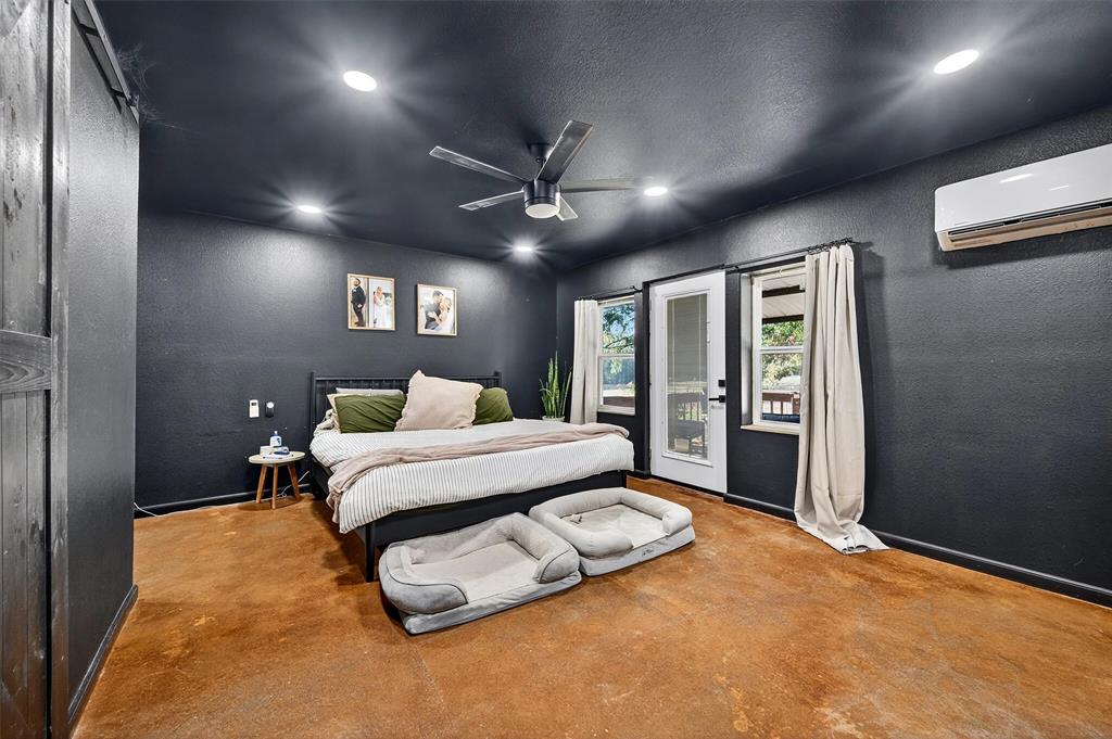 1700 Elmore Road Denison, TX 75021 - Photo 23 of 36 a bed room with a bed and a large mirror