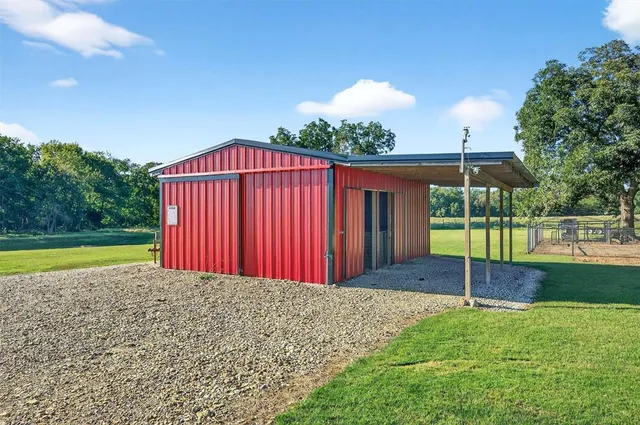 a view of a house with a backyard and a garden