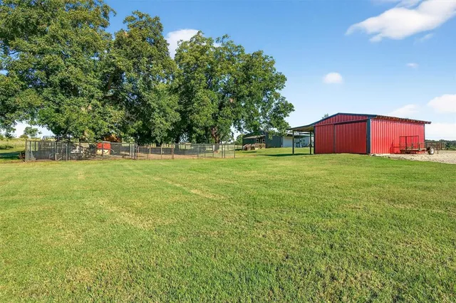 a view of a field of grass and trees