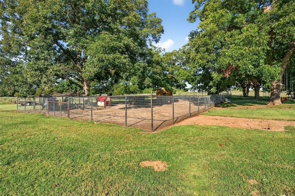 1700 Elmore Road Denison, TX 75021 - Photo 33 of 36 a green field with trees in the background