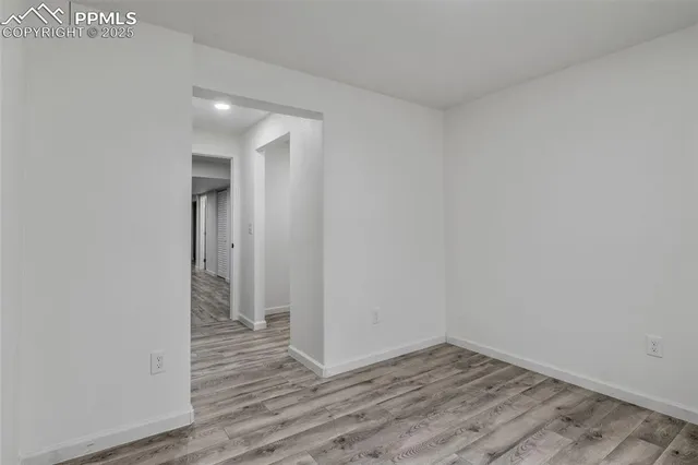 a view of wooden floor and an entryway in a room