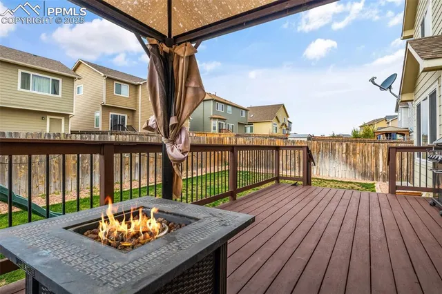 a view of a roof deck with wooden floor and fence