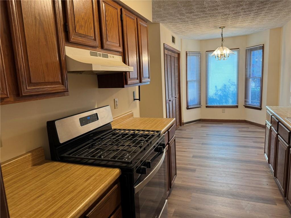 1105 Booth Court Southwest, Unit 1105 Marietta, GA 30008 - Photo 11 of 28 a kitchen with wooden floors and a stove