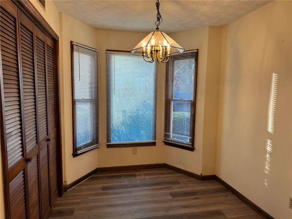 1105 Booth Court Southwest, Unit 1105 Marietta, GA 30008 - Photo 15 of 28 a view of an empty room with wooden floor and a window
