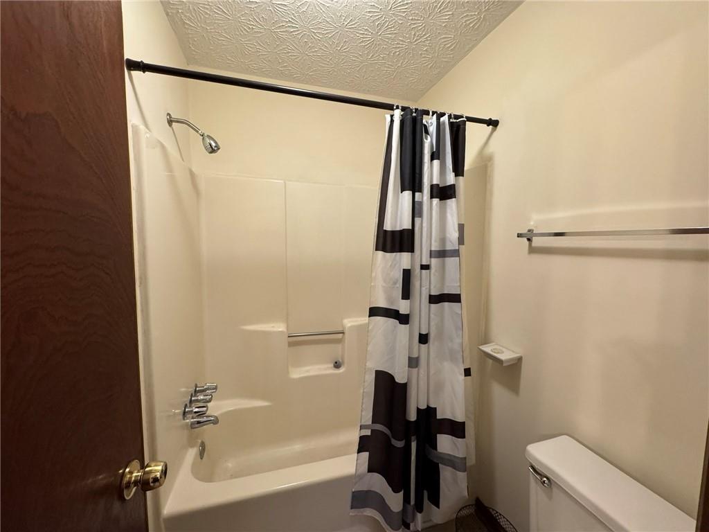 1105 Booth Court Southwest, Unit 1105 Marietta, GA 30008 - Photo 21 of 28 a bathroom with a shower a toilet and a shower