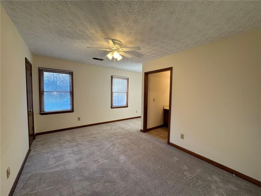 1105 Booth Court Southwest, Unit 1105 Marietta, GA 30008 - Photo 24 of 28 an empty room with windows and closet