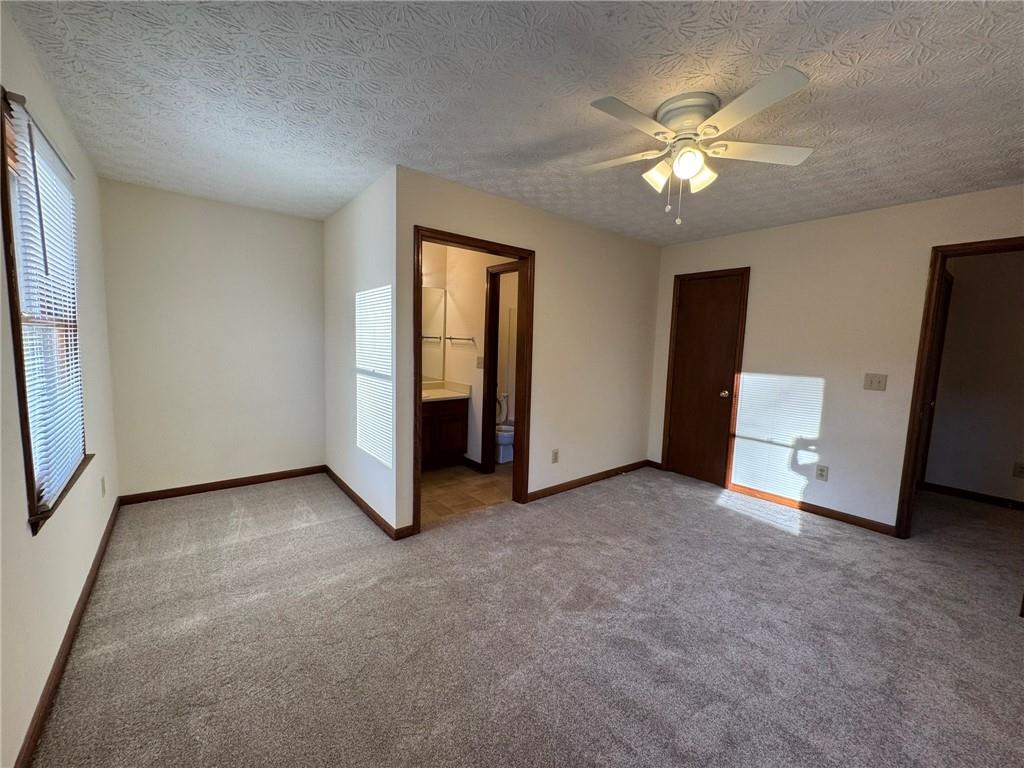 1105 Booth Court Southwest, Unit 1105 Marietta, GA 30008 - Photo 26 of 28 an empty room with chandelier fan and windows